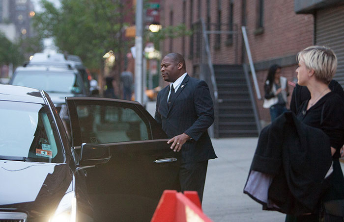 Bodyguard training helping a celebrity exit a limousine