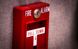 A pull-down fire alarm handle for Fire & Life Safety Director Certification training NYC